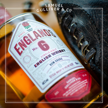 Load image into Gallery viewer, England's No.6 Rum Cask Single Malt English Whisky - The Official Whisky of England Rugby. A close up image of the 700ml bottle with a traditional rugby ball at Twickenham, in celebration of the best No.6's England has ever seen.